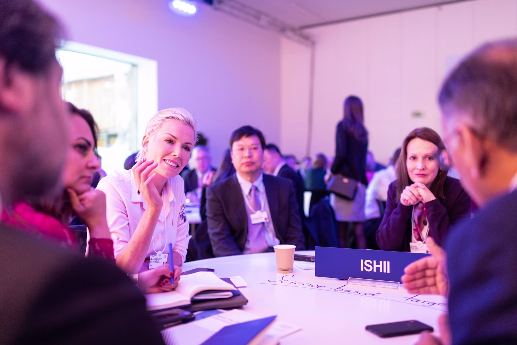Leaders in intentional conversation around a roundtable